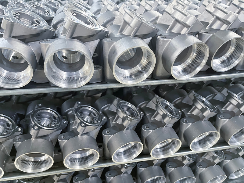 batch of machined die cast aluminum parts placed on a rack, automotive parts mass production, CNC machining, mass production of die casting parts, mass production